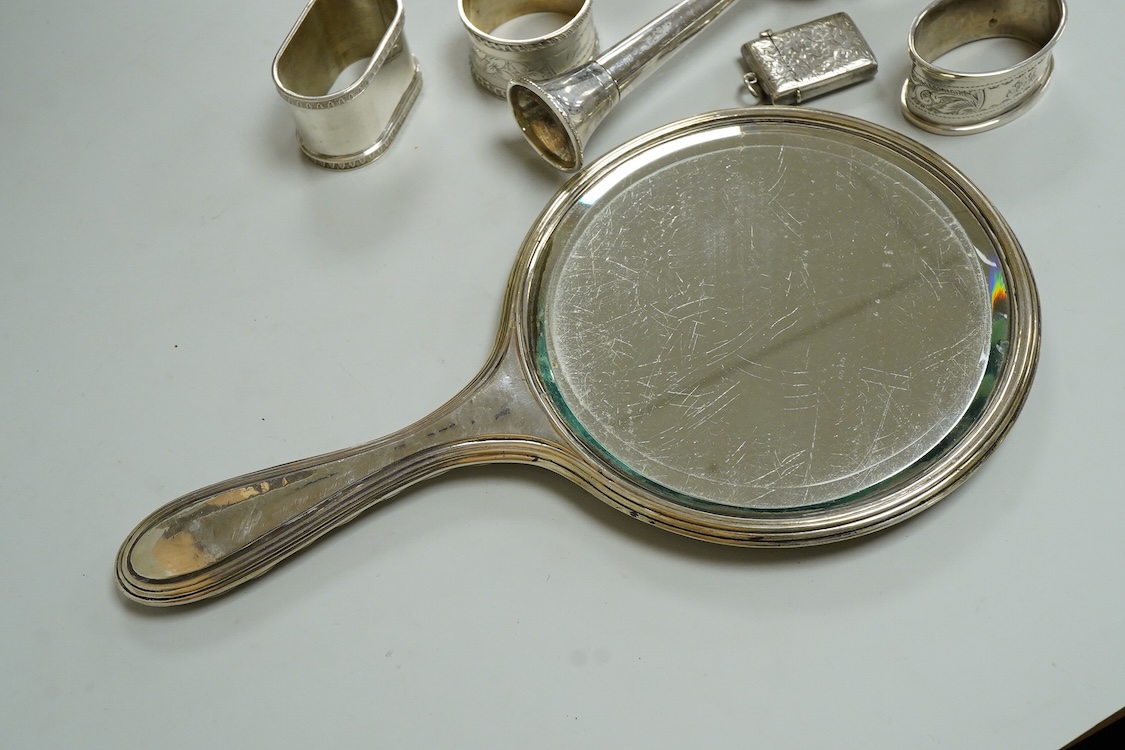Three assorted silver napkin rings, a pair of recent 925 napkin rings, a George V silver mounted hand mirror, a modern silver mounted spill vase and a late Victorian silver vesta case.